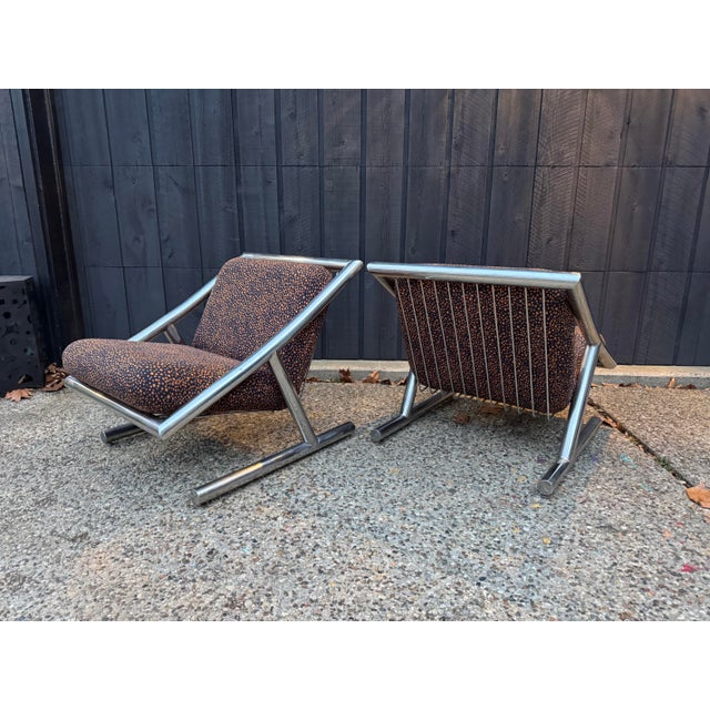 Exceptional pair of Plato Ginello lounge chairs showcasing sculptural chromed tubular steel frames and newly upholstered...