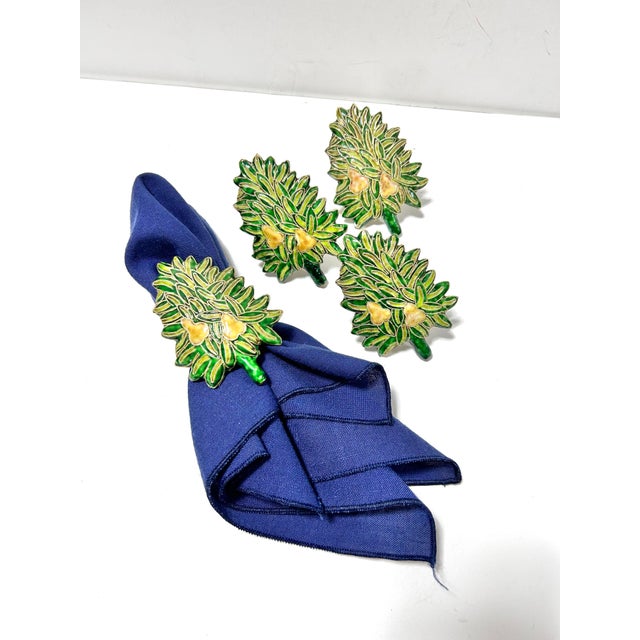 Set of four vintage cloisonné napkin rings shaped like lush green Christmas or pear trees, richly decorated with hand-...