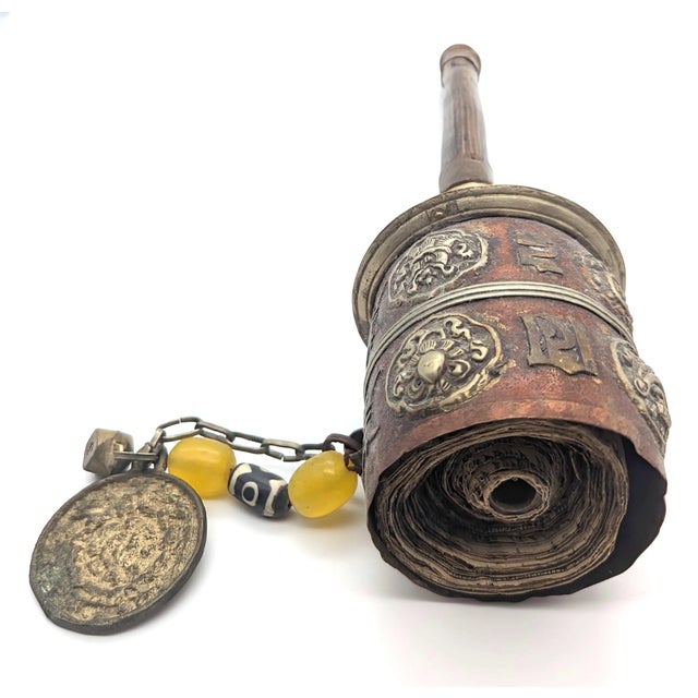 Offered is an antique (late 19th C. to early 20th C.) Tibetan handheld prayer wheel (Mani Khorlo), featuring a repoussé...