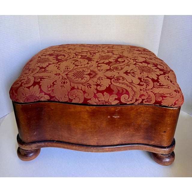 Dating to the late 19th -early 20th century, this charming serpentine-form footstool features a beautifully shaped wooden...