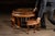 Circular carved hardwood tea table accompanied by four matching wedge-shaped stools that nest neatly beneath the tabletop....
