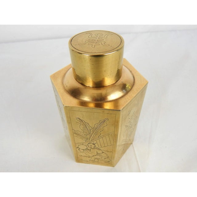 Vintage polished brass hexagonal tea caddy with incised scenes depicted on each panel and lid. Based signed, "Made In China".