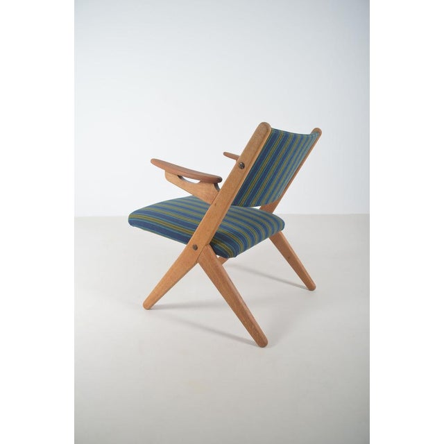 Danish lounge chair designed by Arne Hovmand Olsen in the 1950s. This chair was manufactured by Komfort. The lounge chair...