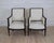 An elegant pair of Swedish Empire style armchairs featuring hand-painted black frames with carved neoclassical detailing....