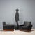 Two vintage armchairs with wooden frames and original black leather upholstery from the period. This piece is attributed...