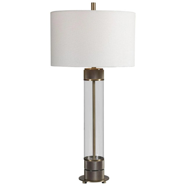 Showcasing A Clean Transitional Look, This Table Lamp Features A Clear Glass Base Accented With Antiqued Brass Plated,...