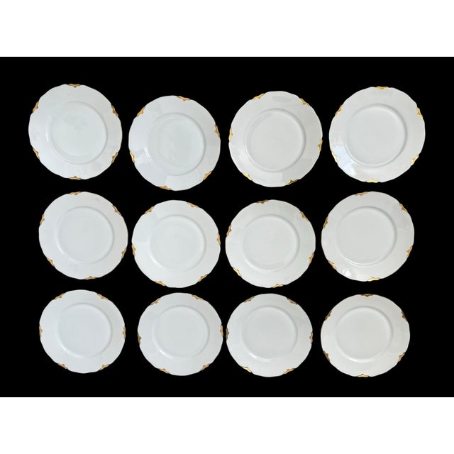 This product is a set of 12 vintage round salad dessert plates made by Heinrich Bavaria Germany. The plates are white with...