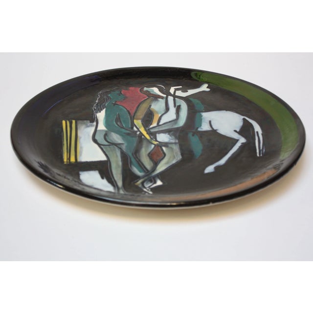 This piece is a fine example of the series of Picasso-inspired ceramic chargers that Luciano Rumi created in the 1950s. It...