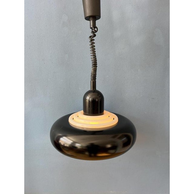 Rare black UFO shaped pendant lamp by Knud Chistensen. The lamp has a metal outer shade and a white, acrylic inner shade....
