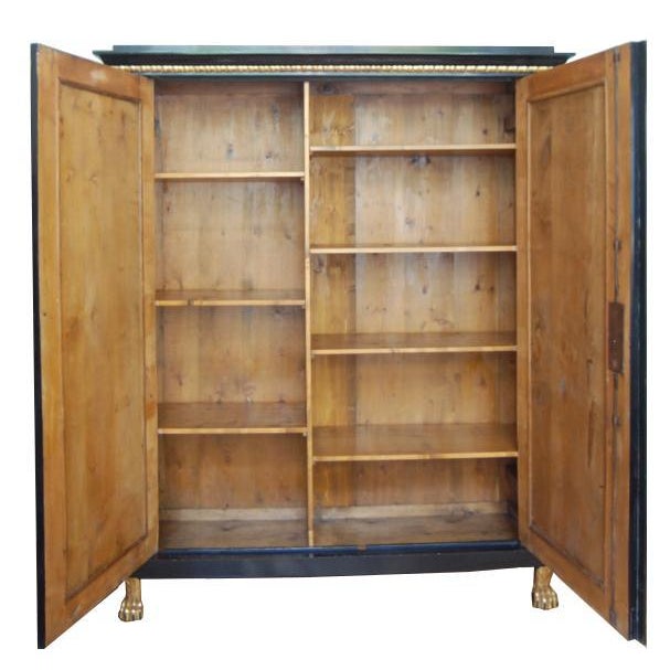 Hall cabinet Vienna around 1800 Empire cabinet, Vienna around 1800. Ebonized pear wood. Two-door body resting on gold-...