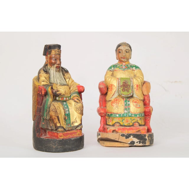 Pair of Chinese wood carved polychrome and gilt decorated figures of a man and a women, circa 1900.