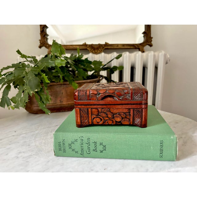 Charming vintage hand-carved camphor wood dresser box, made in China. Has hand carvings of a crane pair and grasses. Well...