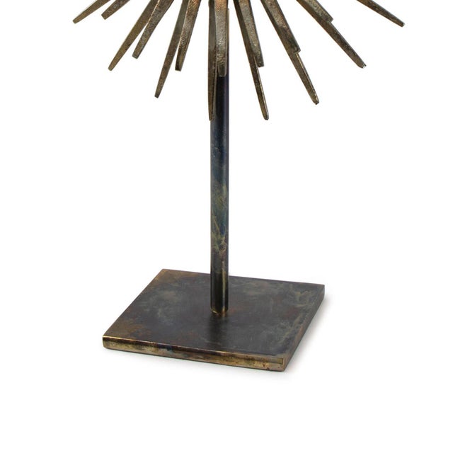 The Industrial-Chic look of the Radiant Sculpture is made possible by its patinated Iron base and spiked mirror surround....