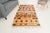 This is a vintage Turkish Oushak rug from the Mid 20th Century. The piece was hand-knotted.