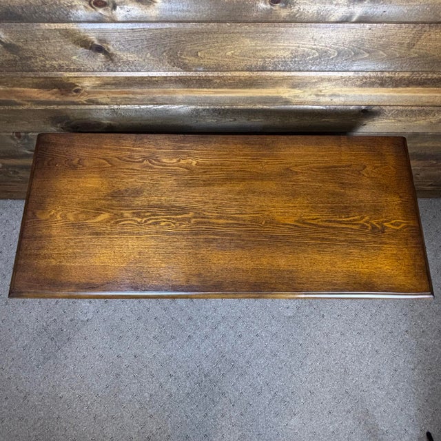 This is a Regency style inspired vintage side table in oak. It features carved accents on the front and scrolled feet....