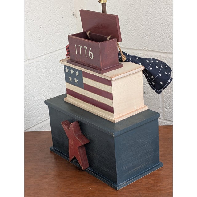 A striking fusion of rustic heritage and bold geometric form, this handcrafted Americana-style table lamp is a standout...