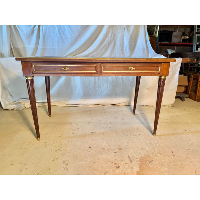 Found in France, this early 20th Century Writing Desk was crafted from Walnut by French artisans in the early 1900's in...