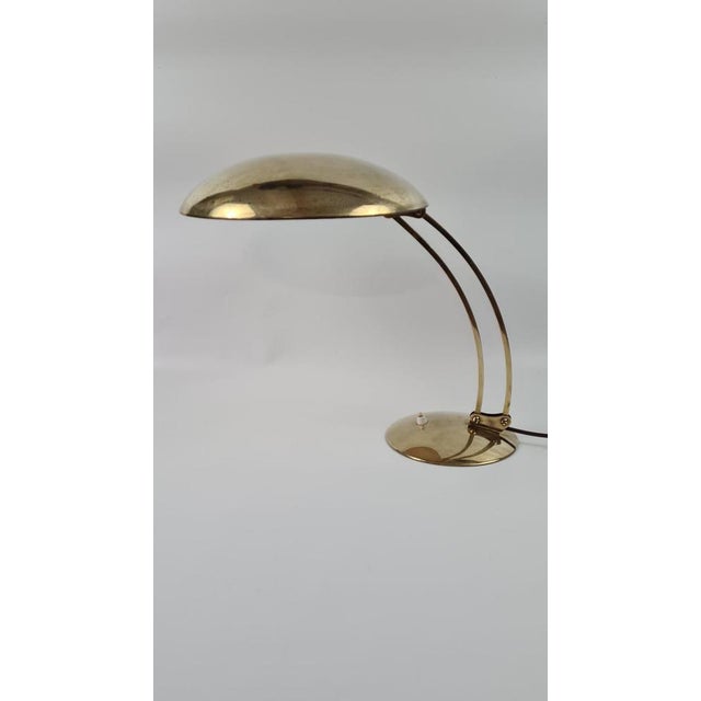 Original brass desk lamp by Christian Dell, model 6764 for Kaiser Idell, Germany. Lampshade, arm, and base made of solid...