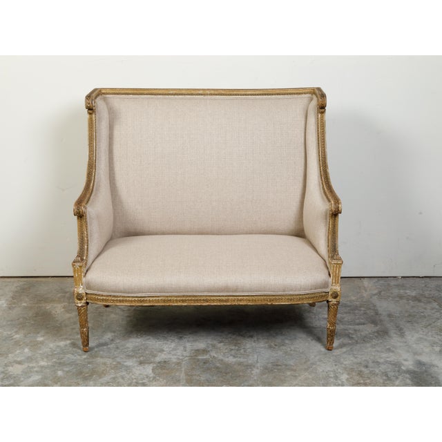 French French 19th Century Louis XVI Style Giltwood Wingback Settee with Carved Motifs For Sale - Image 3 of 10