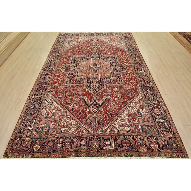 This authentic vintage traditional tribal Heriz rug is hand-knotted with fine wool and natural dyes. This oriental rug...