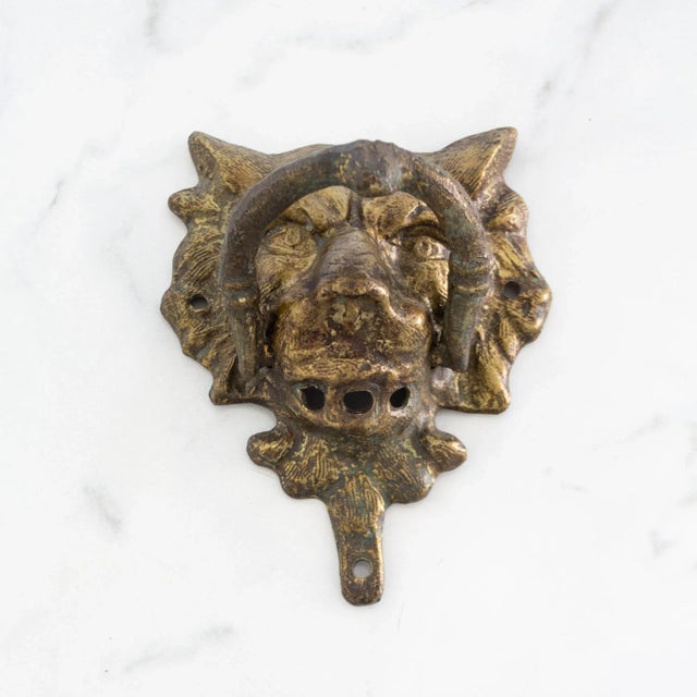 This vintage brass lion's head door knocker boasts a rich natural patina attained through decades of announcing guests at...