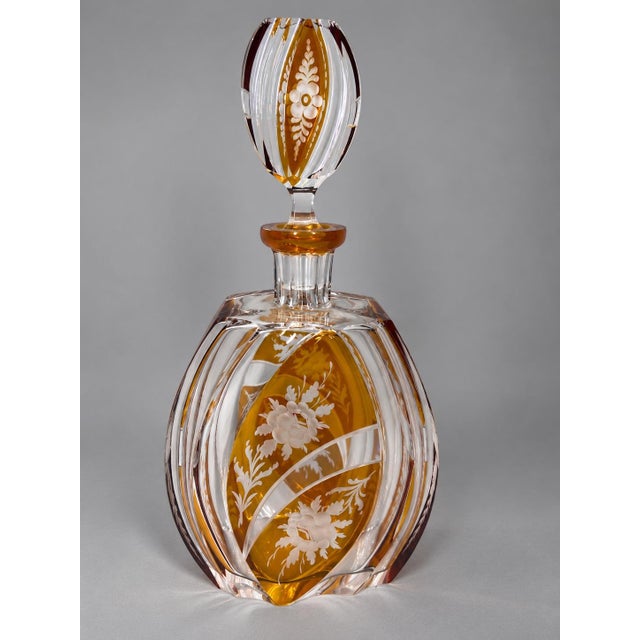This elegant 19th-century Bohemian crystal decanter combines clear faceted crystal with warm amber glass and delicate...