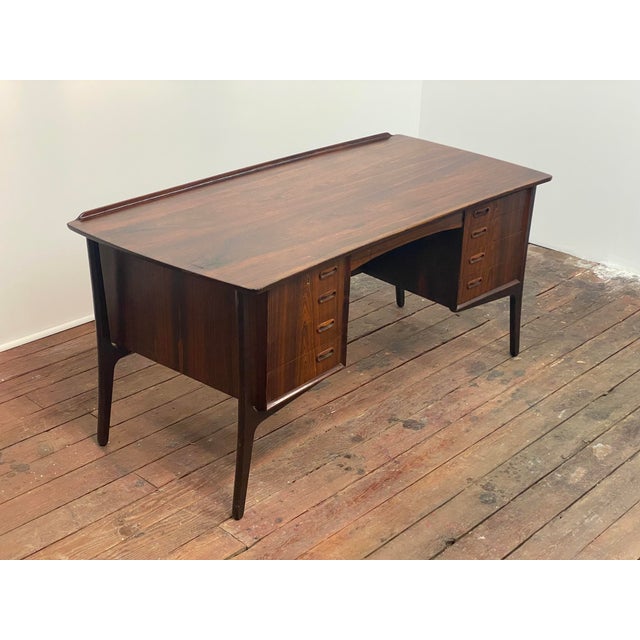 A rosewood desk with bookcase by Svend AgeMAdsen for H.P. Hansen, Denmark. Circa 1960-70. This desk features beautifully...
