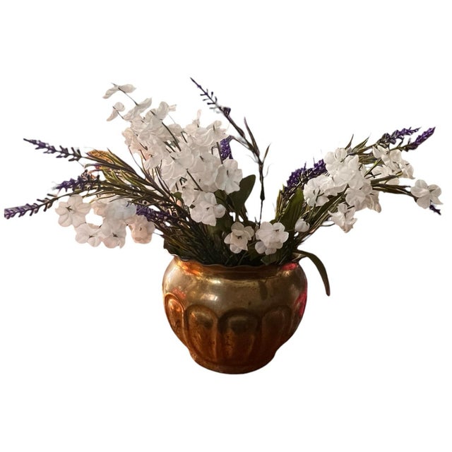 This is a vintage brass planter. It has a beautiful gold color with a natural patina consistent with age. The top of the...