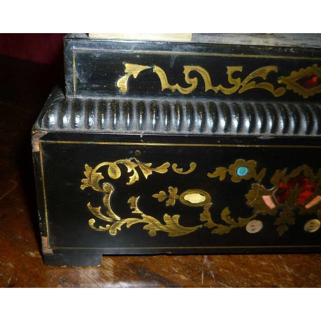 Ebonized Wood Clock is a decorative object realized in the 19th century. Ebony and metal. Good conditions, though some...