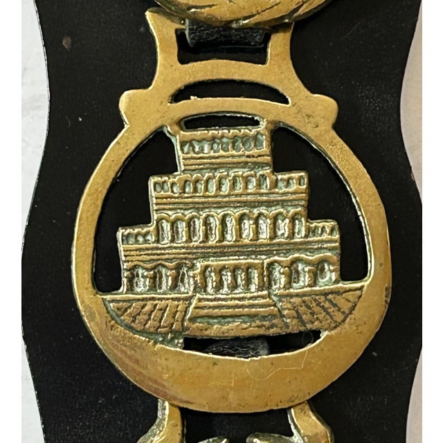 Fresh from a UK trip, this English Martingale leather horse bridle strap with five cast brasses; Dereham, hoof, hunting...