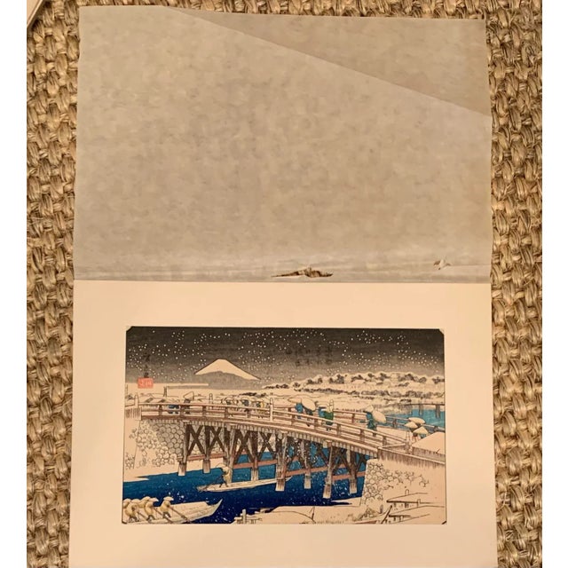 Vintage Japanese wood block print artwork by Utagawa Hiroshige. Depicts the Ikkoku Bridge with a view of Mt. Fuji.