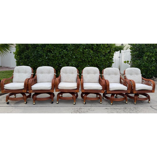 Vintage palm beach style rattan armchairs, offered as a set of six. These distinctive chairs feature beautifully shaped...
