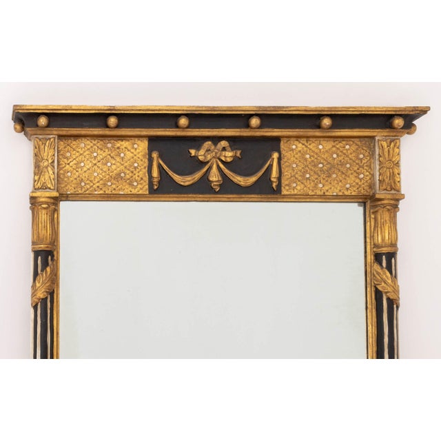 Italian Neoclassical Style Ebonized and Giltwood Mirror, with garland and swag motif. Mirror plate: 41.5" H x 23.25" W;...
