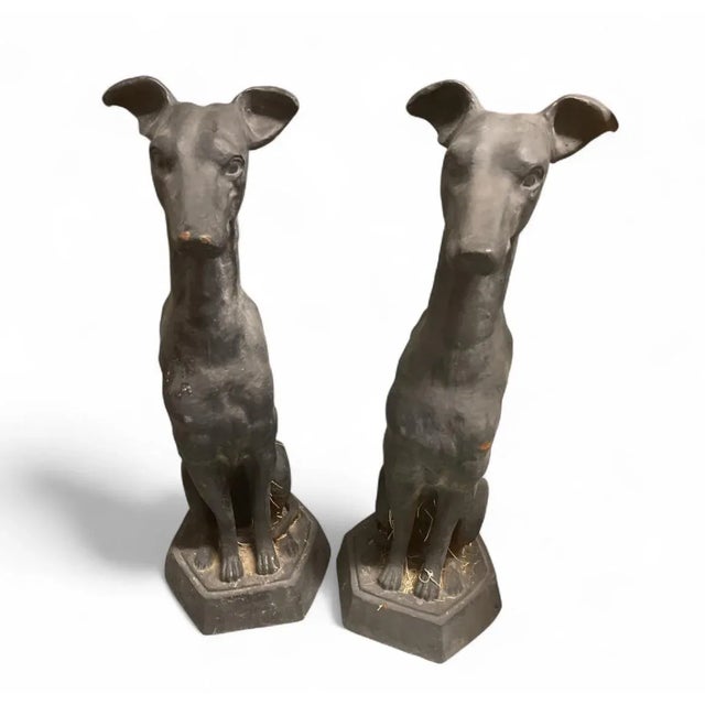 This magnificent pair of large, antique cast iron statues depicts two elegantly seated Greyhound dogs. The statues possess...