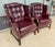 This pair of vintage wingback chairs by Classic Leather features rich maroon leather upholstery with deep button tufting,...