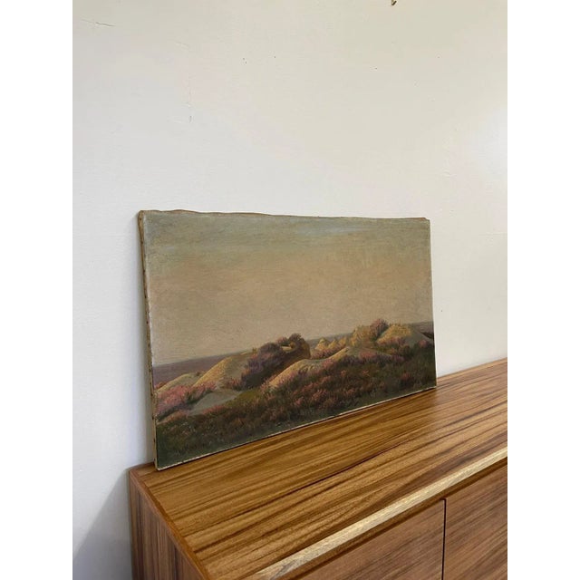 Possibly oil or acrylic on Canvas, stretched and nailed to the frame. Anonymous maker. Painting features a hillside with...