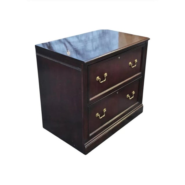 A two drawer lateral two-Drawer cherry Executive filing cabinet. Two deep drawers independently locking. Glossy varnish...