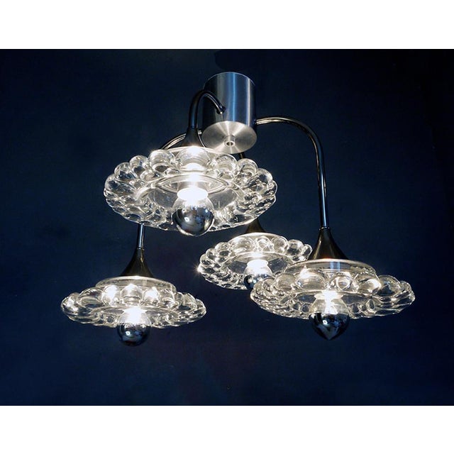 Elegant mid-century modern sputnik flush mount with four clear bubbled murano glasses on a chromed frame. Star-shaped...