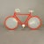 Bicycle-shaped table or wall lamp by Zicoli from the 1970s. Brick red enameled metal frame, white enameled metal...