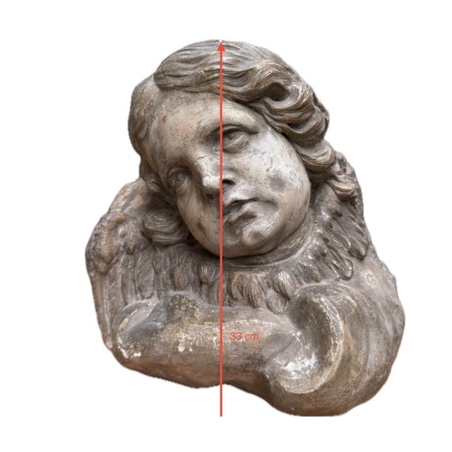 This delicate bust depicts a cherub with youthful features, his head tilted with an expression imbued with gentleness and...
