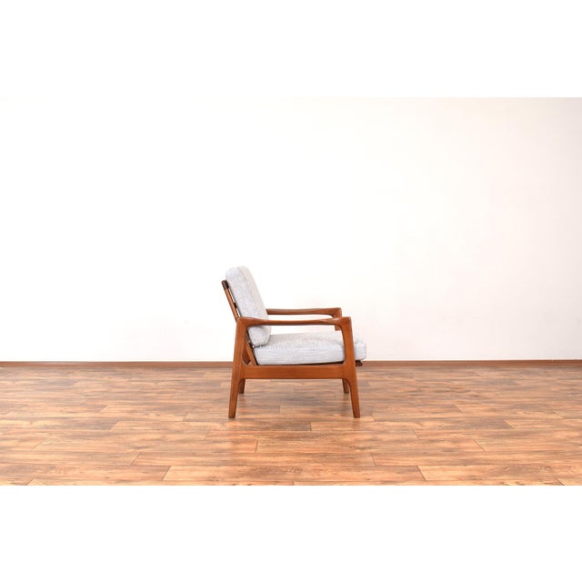 This armchair was designed in the 1960s by Illum Wikkelsø. The lounge chair frame is made of cherry wood and has has been...
