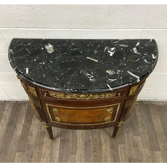 This is a stunning vintage French Louis XVI style gilt and marquetry marble top chest of drawers, commode, buffet or...