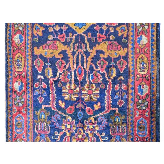 A wonderful early 20th century Persian Kashan rug with an all-over tribal floral and vine pattern woven in gold, light...
