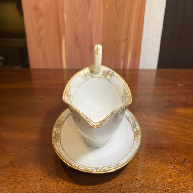 Refined early 20th Century sauce/gravy boat. Hand painted pink and blue flowers with gilded gold borders. *Acquired from...