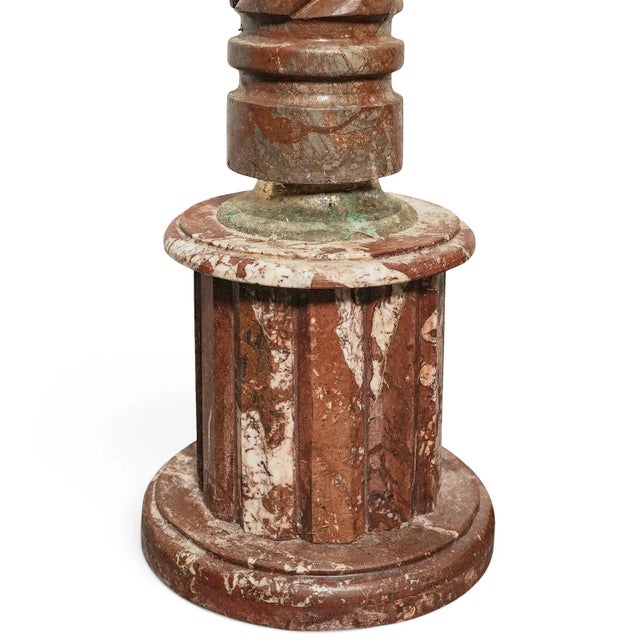 The product is a pair of antique red marble twisted pedestals, showcasing a classic and elegant design typical of antique...