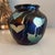 A beautiful piece of iridescent art glass in the style of Tiffany, Durand, and Lundberg. This petite vase features a...