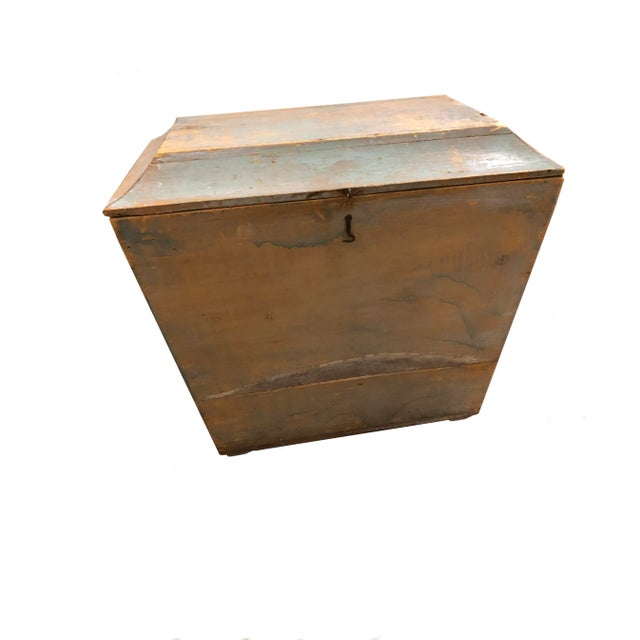 An antique wooden storage box with original paint and a hinged top. From Switzerland, circa 1900.