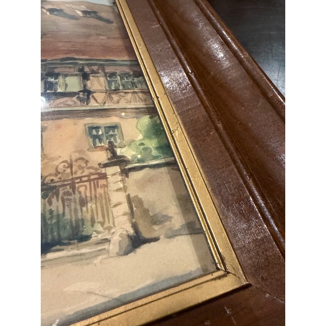 Charming vintage watercolor depicting a picturesque European village or townscape, rendered in a loose, expressive style...