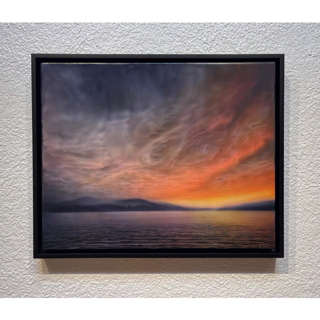 Afterburn captures a serene twilight landscape where vibrant hues of orange and pink blend seamlessly into cooler tones of...