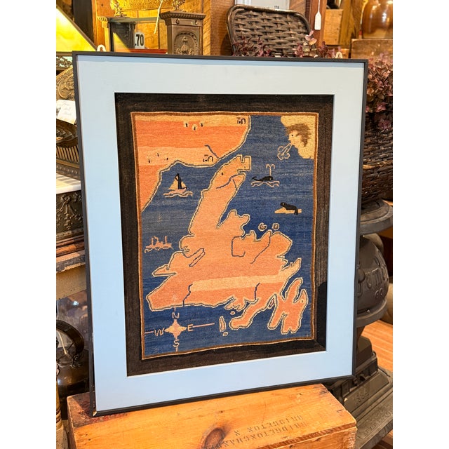 A rare and highly collectible vintage Grenfell hooked mat featuring a stylized map of Newfoundland and Labrador,...